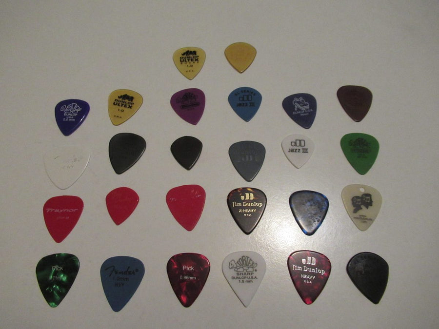 Guitar picks and strings an assortment of picks